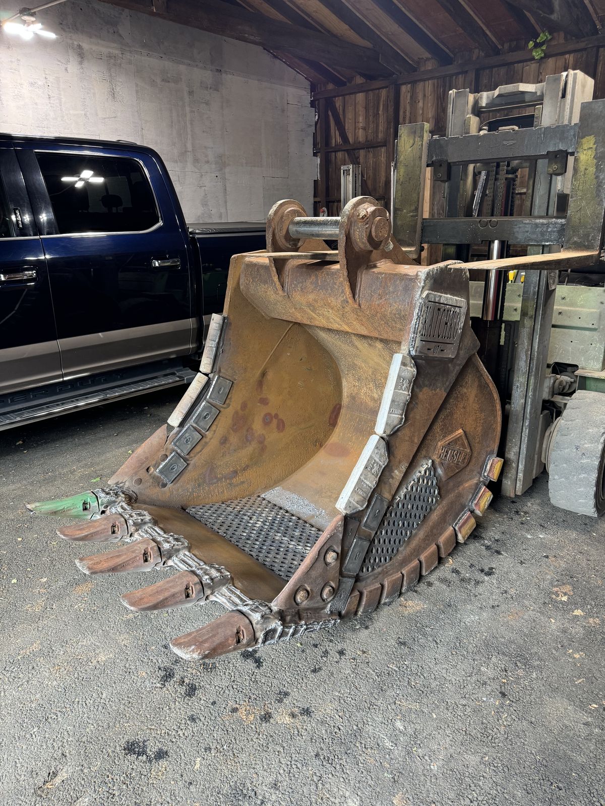 Excavator bucket rebuilt — new teeth, cutting edge, and wear plates