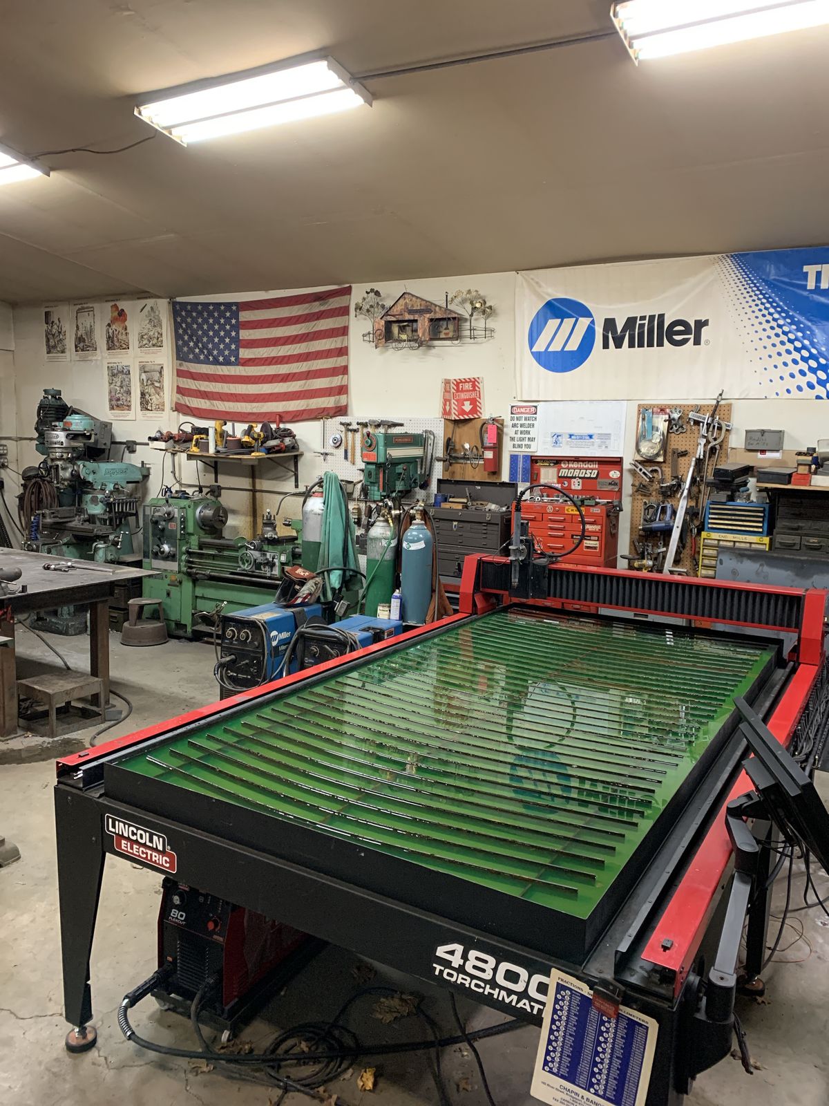 The shop — CNC plasma table, mills, lathes, and 45 years of tooling